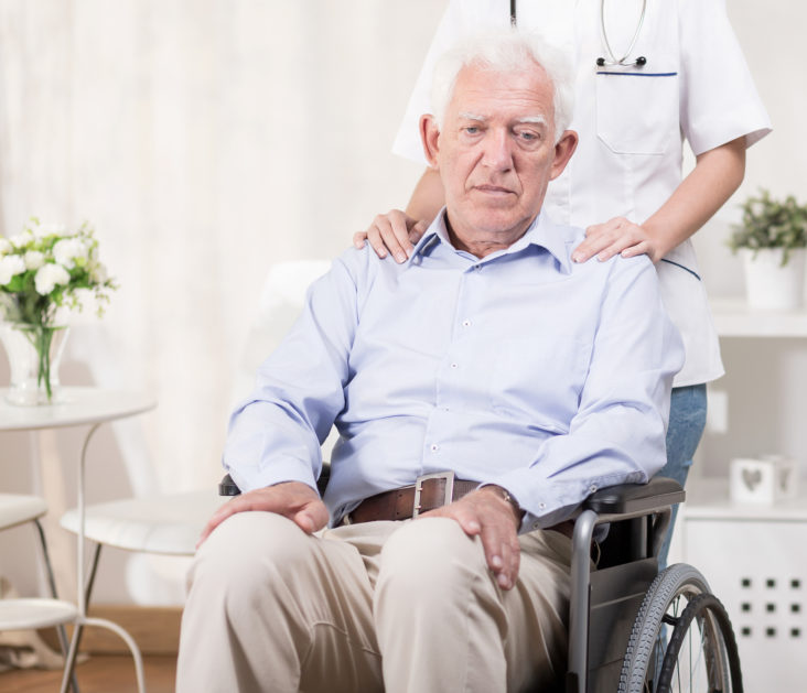 Sad elderly man on wheelchair