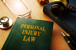 personal injury lawyer Scottsdale, AZ with a book and stethoscope on a table