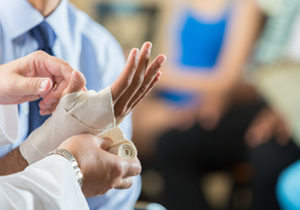Personal-Injury-Attorney-Scottsdale-AZ-man-getting-hand-wrapped-by-doctor